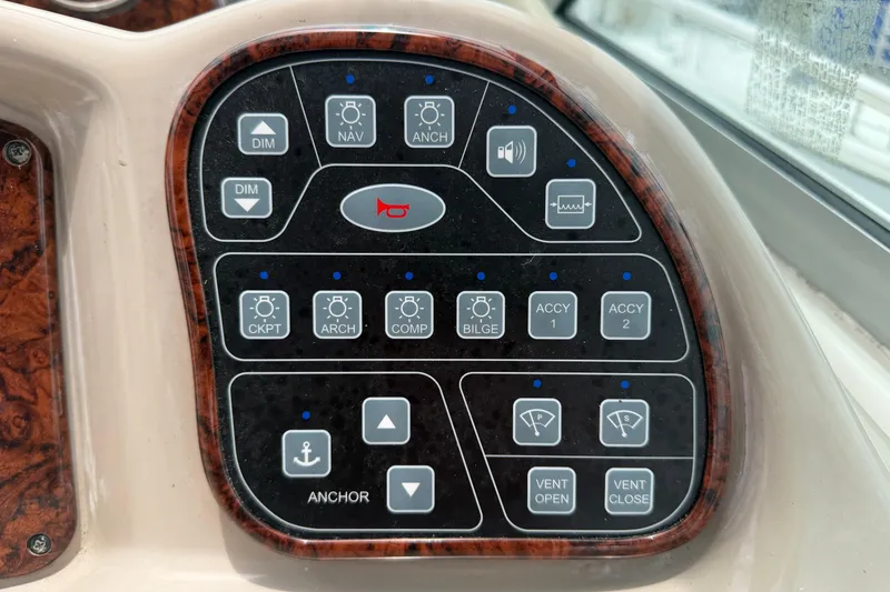 Slide: The Image of Control panel of a 2006 Sea Ray Sundancer 320 boat with various function buttons. - 10