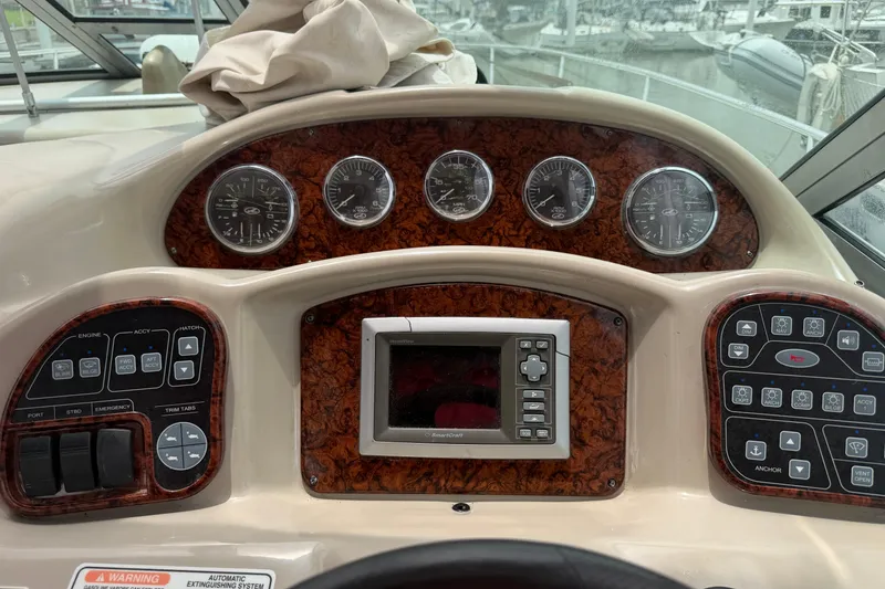 Slide: The Image of 2006 Sea Ray Sundancer 320 dashboard with gauges and control panels. - 11