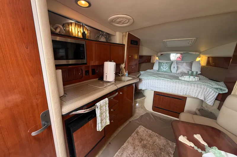 Slide: The Image of 2006 Sea Ray Sundancer 320 interior with kitchenette and cozy sleeping area. - 14