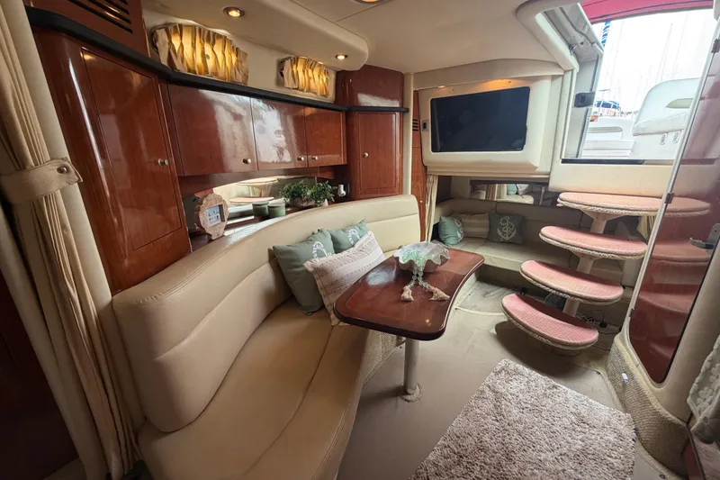 Slide: The Image of Luxurious interior of a 2006 Sea Ray Sundancer 320 yacht with elegant seating and wooden cabinetry. - 16