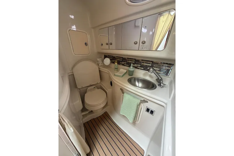 Slide: The Image of 2006 Sea Ray Sundancer 320 bathroom with sink, toilet, and storage cabinets. - 19