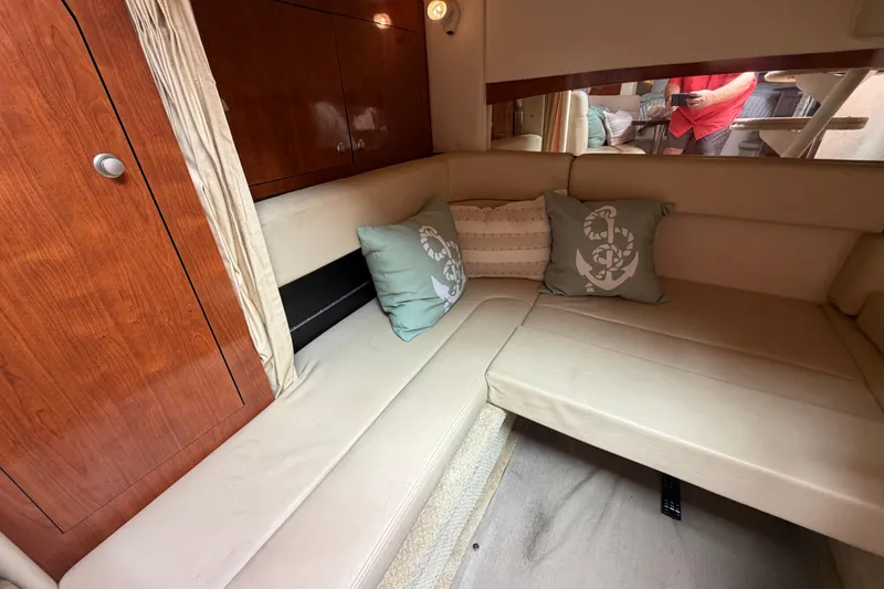 Slide: The Image of Luxurious interior of 2006 Sea Ray Sundancer 320 with beige seating and decorative pillows. - 22