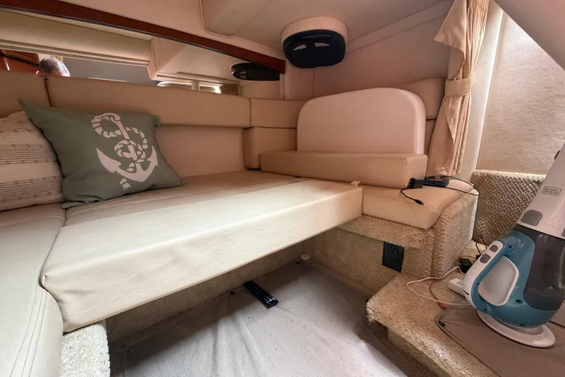 Slide: The Image of Interior cabin of 2006 Sea Ray Sundancer 320 with beige seating and nautical-themed pillow. - 23