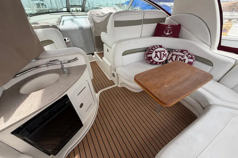 Slide: The Image of Interior of 2006 Sea Ray Sundancer 320 yacht with seating, table, and kitchenette. - 6