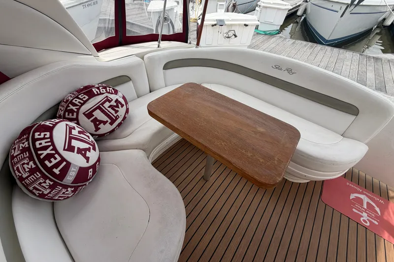 Slide: The Image of Interior of 2006 Sea Ray Sundancer 320 with Texas A&M cushions and wooden table. - 7