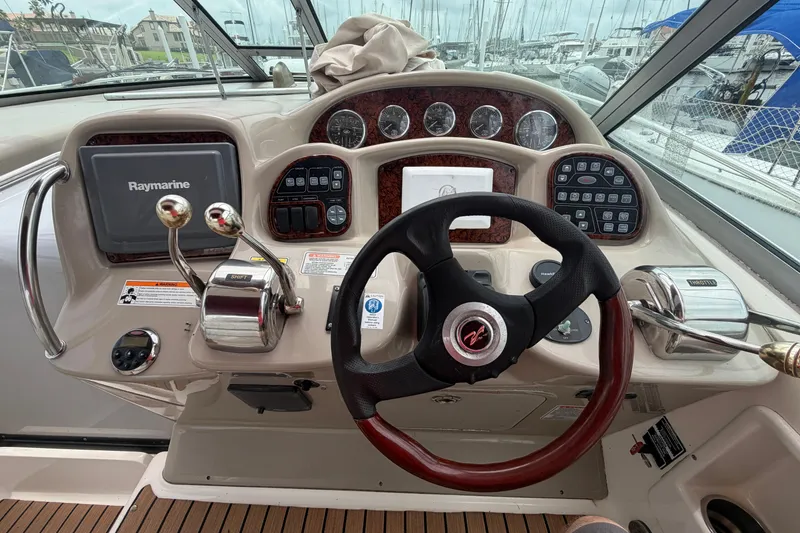 Slide: The Image of Cockpit of 2006 Sea Ray Sundancer 320 with steering wheel and Raymarine navigation system. - 9