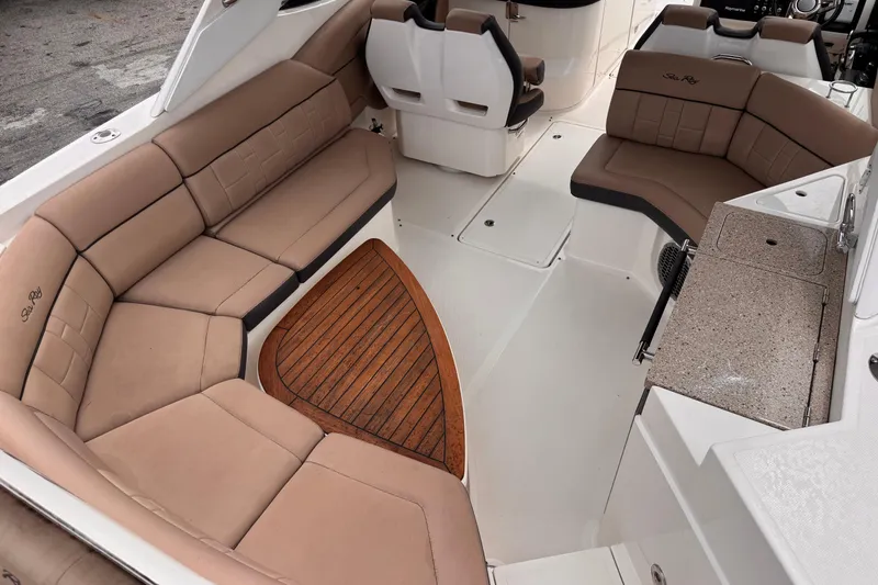 Slide: The Image of 2016 Sea Ray SLX 350 boat interior with tan seating and wood accents. - 12