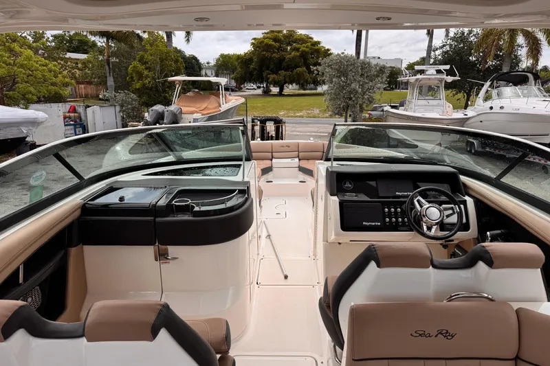 Slide: The Image of 2016 Sea Ray SLX 350 boat interior with helm, seating, and dashboard. - 14