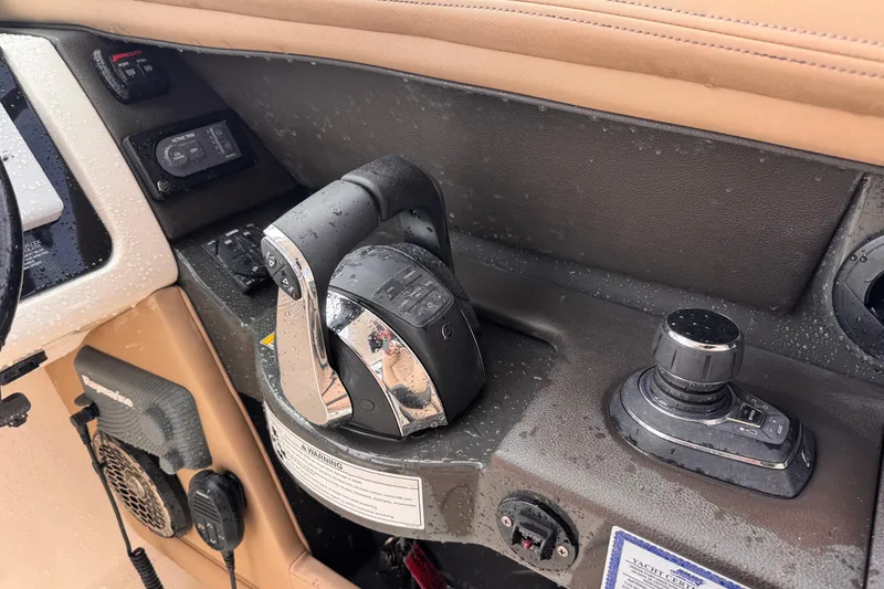 Slide: The Image of Control panel of a 2016 Sea Ray SLX 350 boat, featuring throttle and joystick controls. - 17