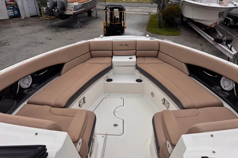 Slide: The Image of 2016 Sea Ray SLX 350 boat interior with tan seating and cup holders. - 19