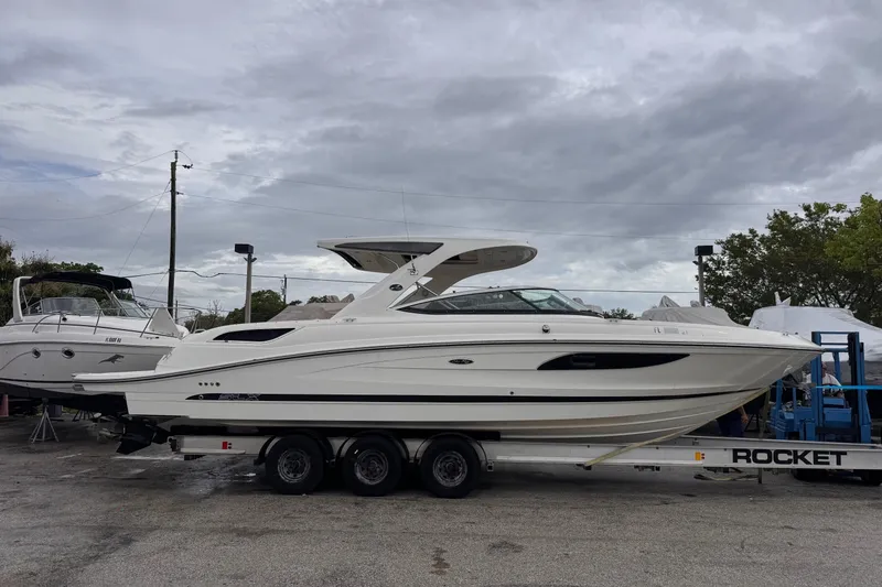 Slide: The Image of 2016 Sea Ray SLX 350 boat on trailer under cloudy sky. - 2