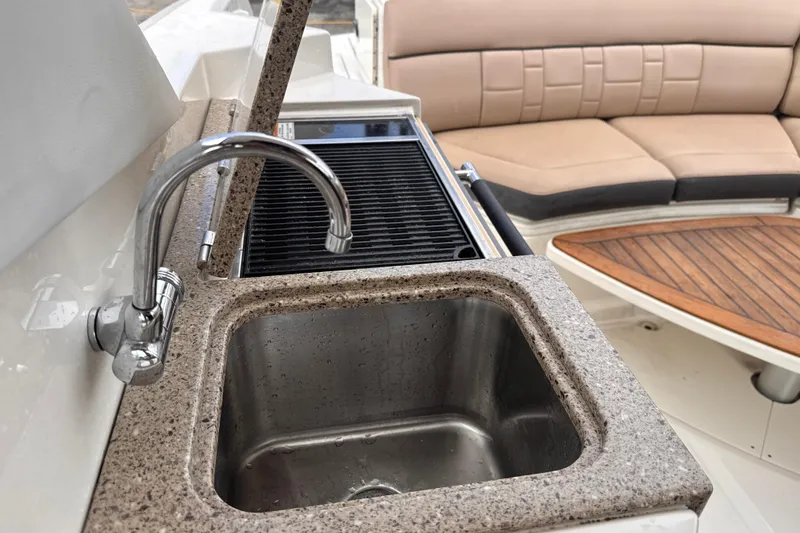 Slide: The Image of Luxury Sea Ray SLX 350 boat interior with sink, grill, and seating area, 2016 model. - 23