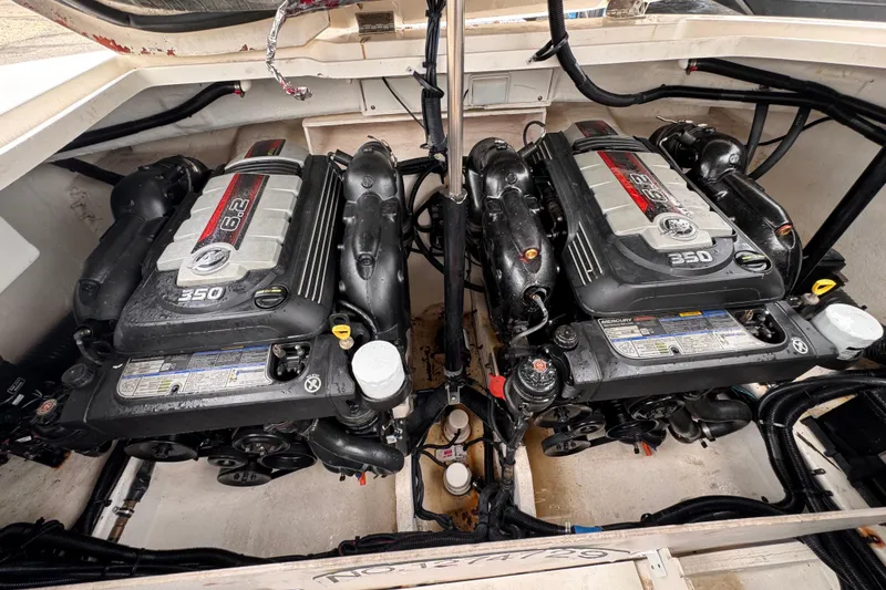 Slide: The Image of Twin Mercury 6.2L engines in a 2016 Sea Ray SLX 350 boat engine compartment. - 25
