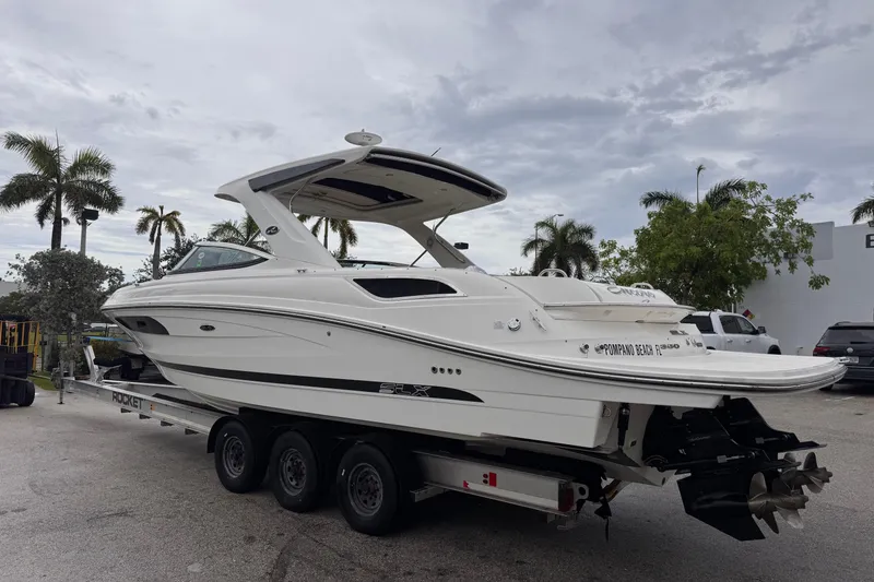 Slide: The Image of 2016 Sea Ray SLX 350 boat on trailer, parked outdoors with palm trees. - 4