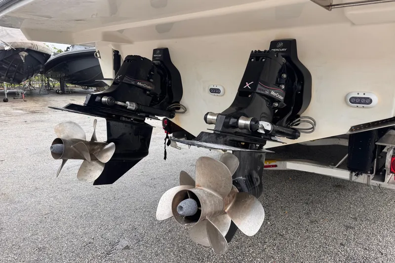 Slide: The Image of Twin propellers on a 2016 Sea Ray SLX 350 boat, parked on gravel. - 6