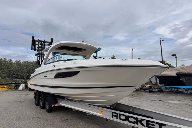 Slide: The Image of 2016 Sea Ray SLX 350 boat on trailer under cloudy sky. - 8