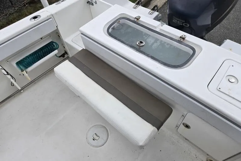 Slide: The Image of 2011 Sea Hunt Triton 240 boat interior with seating and storage compartments. - 1