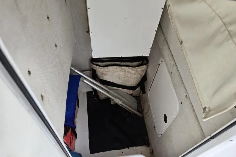 Slide: The Image of Interior storage area of a 2011 Sea Hunt Triton 240 boat with equipment. - 12