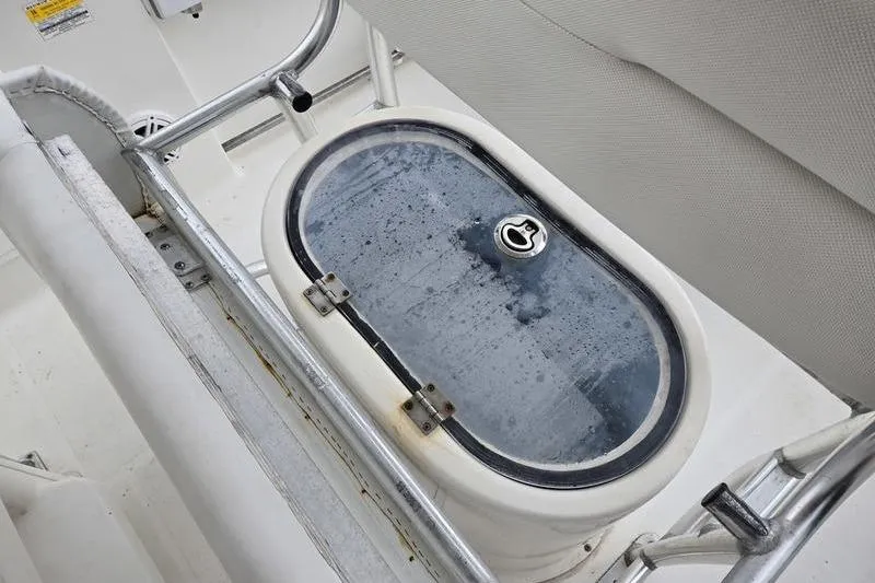 Slide: The Image of Livewell on 2011 Sea Hunt Triton 240 boat, featuring stainless steel railing. - 14