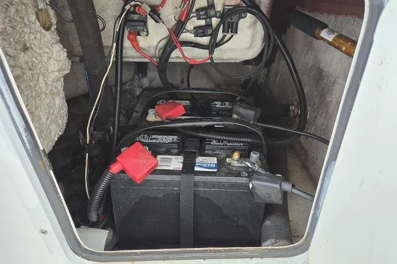 Slide: The Image of Battery compartment of a 2011 Sea Hunt Triton 240 boat with wiring and connections. - 15