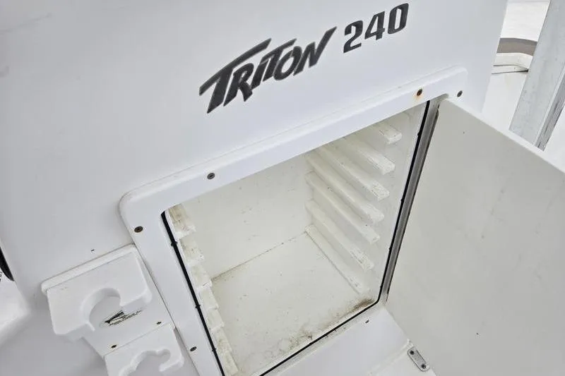 Slide: The Image of Open storage compartment on a 2011 Sea Hunt Triton 240 boat. - 16