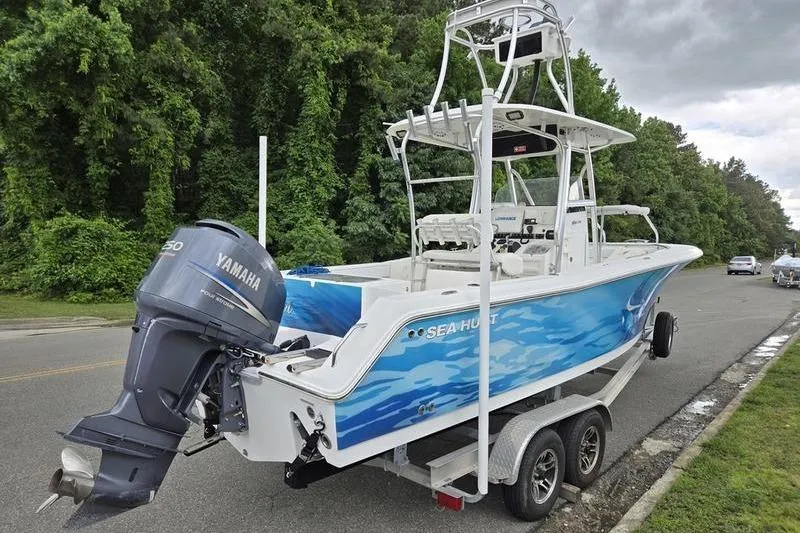 Slide: The Image of 2011 Sea Hunt Triton 240 boat with Yamaha engine on trailer, parked roadside. - 17