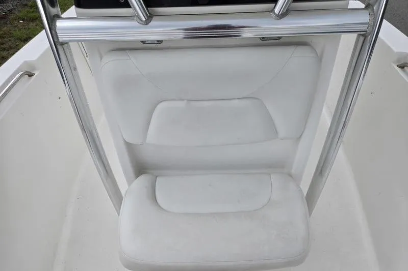 Slide: The Image of 2011 Sea Hunt Triton 240 boat seat with white upholstery and stainless steel frame. - 2
