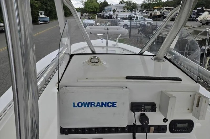 Slide: The Image of 2011 Sea Hunt Triton 240 boat dashboard with Lowrance equipment and navigation controls. - 5