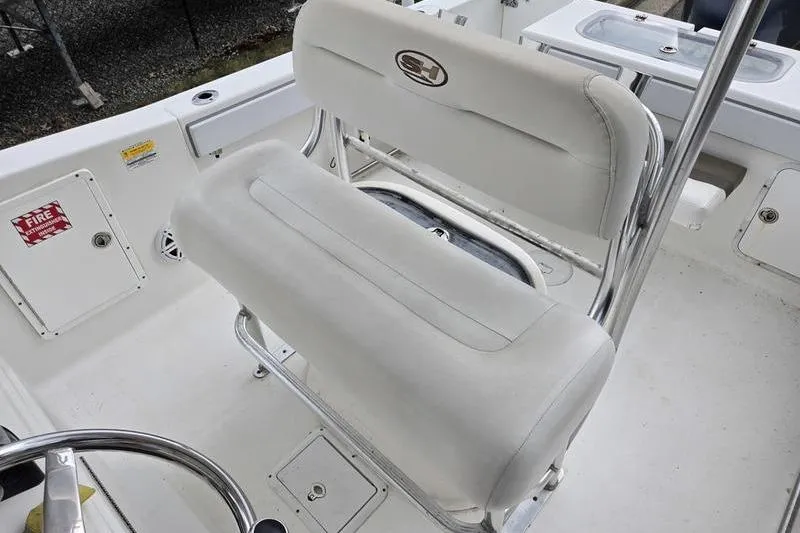Slide: The Image of 2011 Sea Hunt Triton 240 boat interior with white seating and storage compartments. - 7