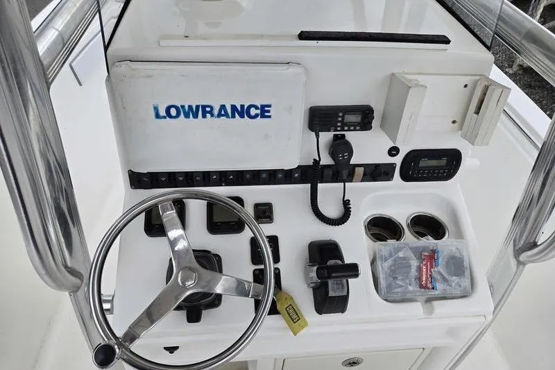 Slide: The Image of 2011 Sea Hunt Triton 240 boat console with steering wheel and Lowrance equipment. - 8
