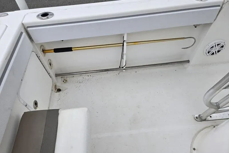 Slide: The Image of Interior of a 2011 Sea Hunt Triton 240 boat showing seating and storage area. - 9