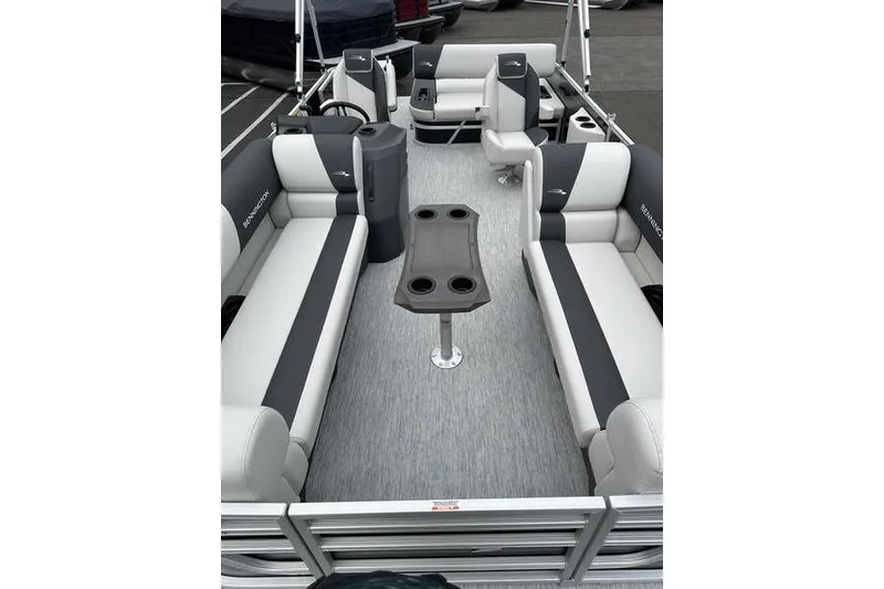 Slide: The Image of 2026 Bennington S Swingback 22 SSB pontoon boat interior with gray seating and table. - 13