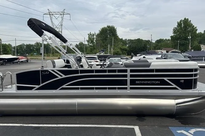 Slide: The Image of 2026 Bennington S Swingback 22 SSB pontoon boat in parking lot, side view. - 4