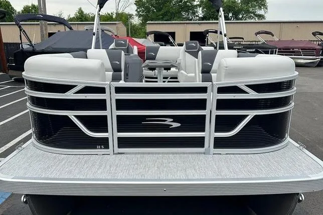 Slide: The Image of 2026 Bennington S Swingback 22 SSB pontoon boat, front view in a marina setting. - 6