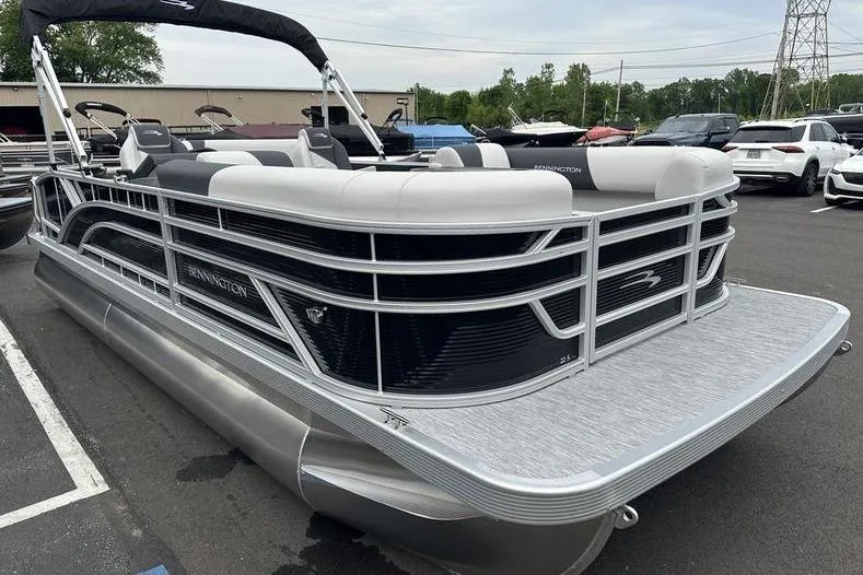 Slide: The Image of 2026 Bennington S Swingback 22 SSB pontoon boat in a parking lot. - 7