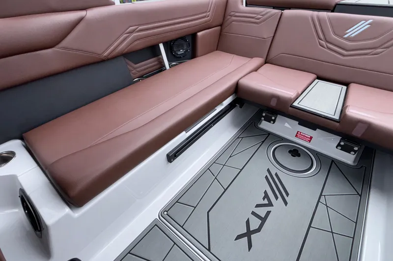 Slide: The Image of 2026 ATX Surf Boats 24 Type-S interior with brown seating and custom flooring. - 16
