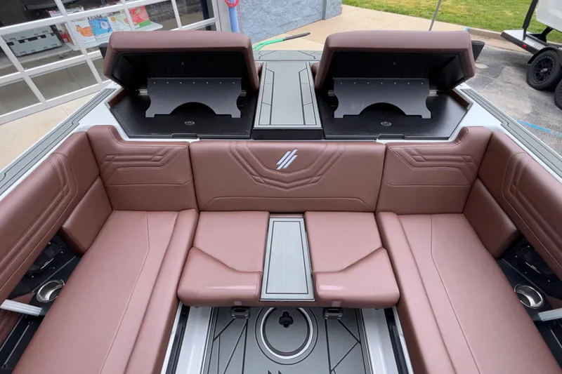 Slide: The Image of 2026 ATX Surf Boats 24 Type-S interior with brown seating and storage compartments. - 21