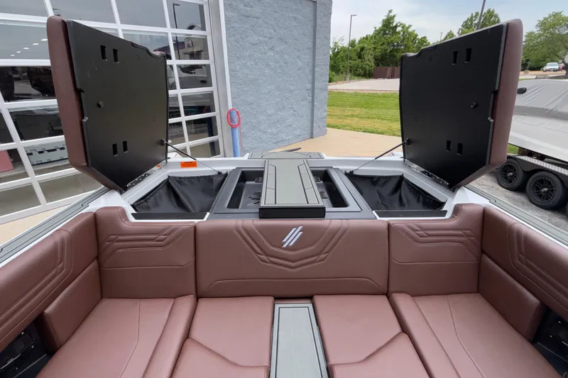 Slide: The Image of 2026 ATX Surf Boats 24 Type-S interior with open storage compartments and brown seating. - 23