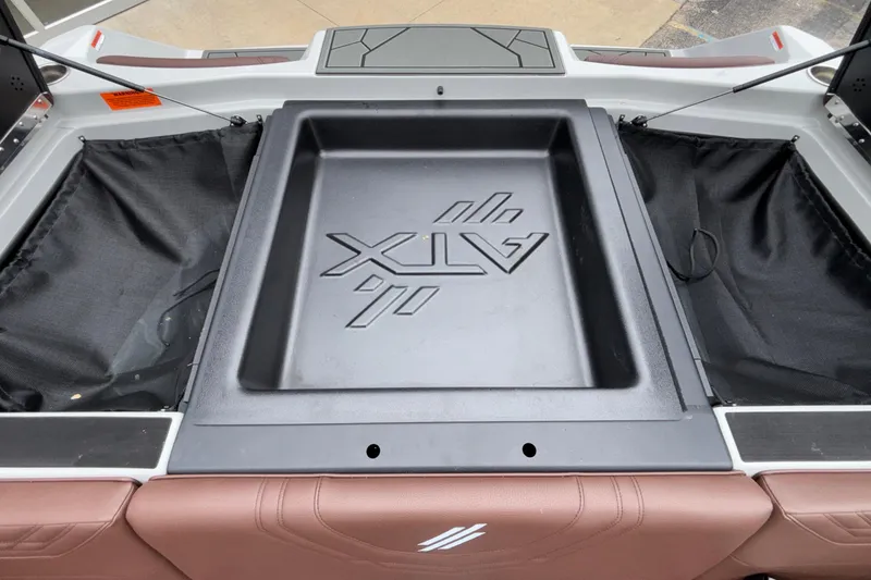 Slide: The Image of 2026 ATX Surf Boats 24 Type-S rear storage compartment with logo detail. - 24