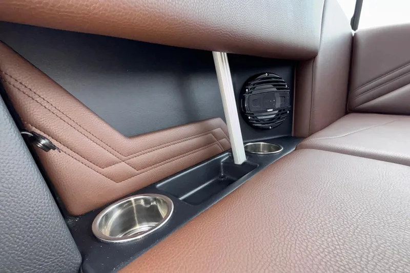 Slide: The Image of 2026 ATX Surf Boats 24 Type-S interior with brown leather seats, cup holders, and speaker. - 29