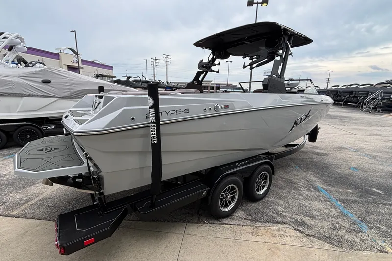Slide: The Image of 2026 ATX Surf Boats 24 Type-S on trailer, sleek design, parked outdoors. - 3