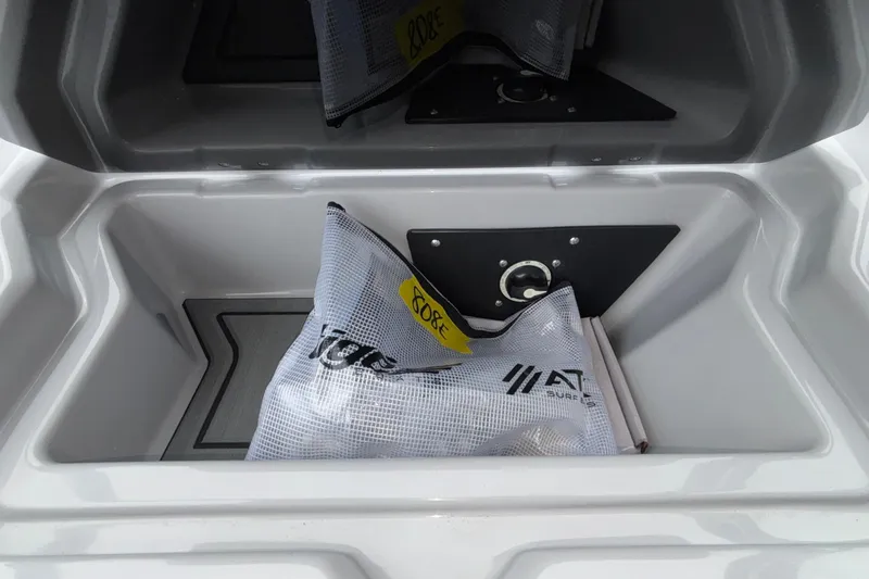 Slide: The Image of Storage compartment of 2026 ATX Surf Boats 24 Type-S with gear bag inside. - 51