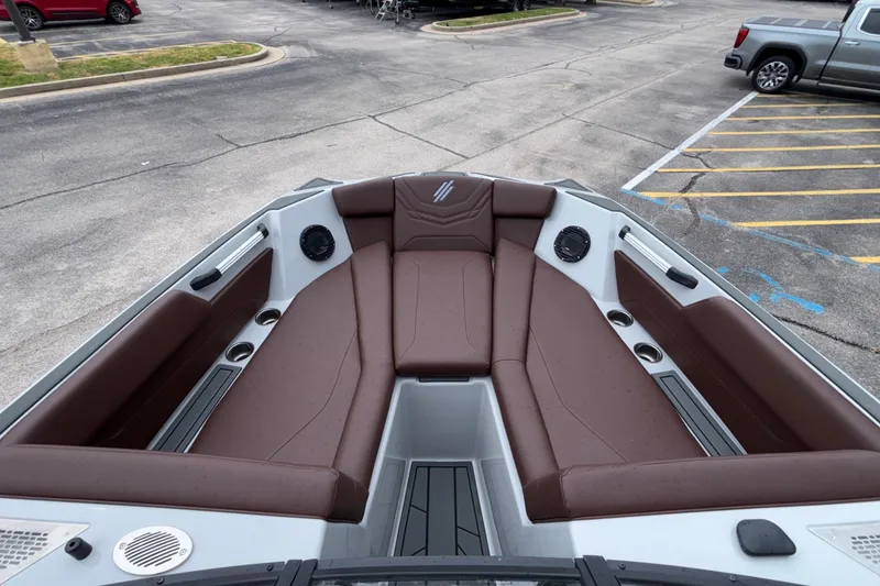 Slide: The Image of 2026 ATX Surf Boats 24 Type-S with brown seating, parked in a lot. - 52