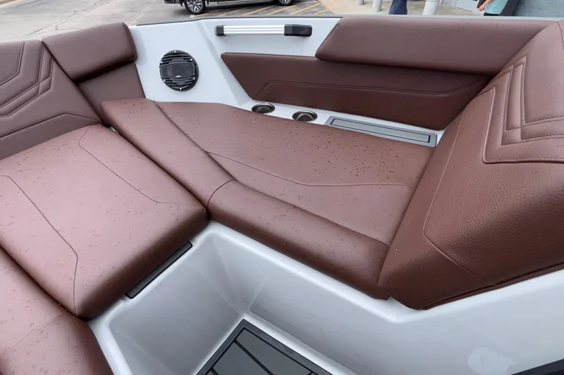 Slide: The Image of Luxurious brown seating in 2026 ATX Surf Boats 24 Type-S, featuring cup holders and speaker. - 55
