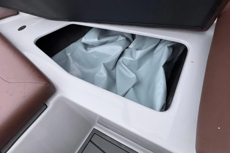 Slide: The Image of Storage compartment in 2026 ATX Surf Boats 24 Type-S, featuring brown seating and white interior. - 57