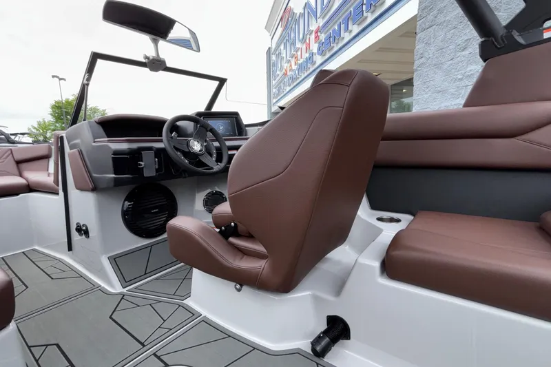 Slide: The Image of Interior of 2026 ATX Surf Boats 24 Type-S with brown seating and modern dashboard. - 60