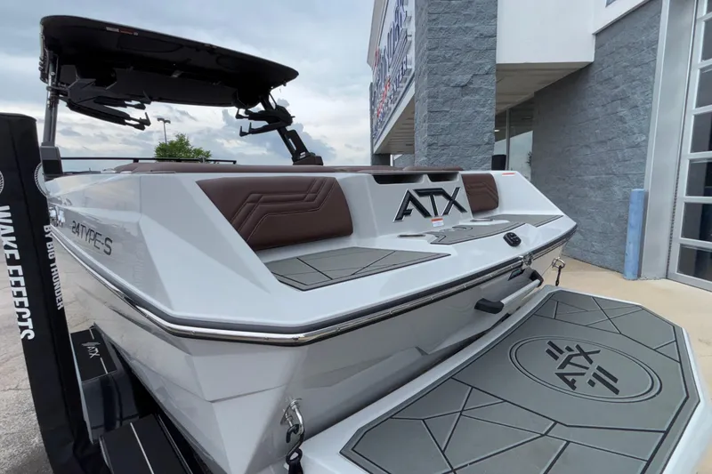 Slide: The Image of 2026 ATX Surf Boats 24 Type-S, sleek design, docked near a modern building. - 7