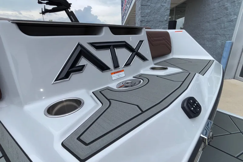 Slide: The Image of 2026 ATX Surf Boats 24 Type-S rear deck with logo and cup holders. - 8