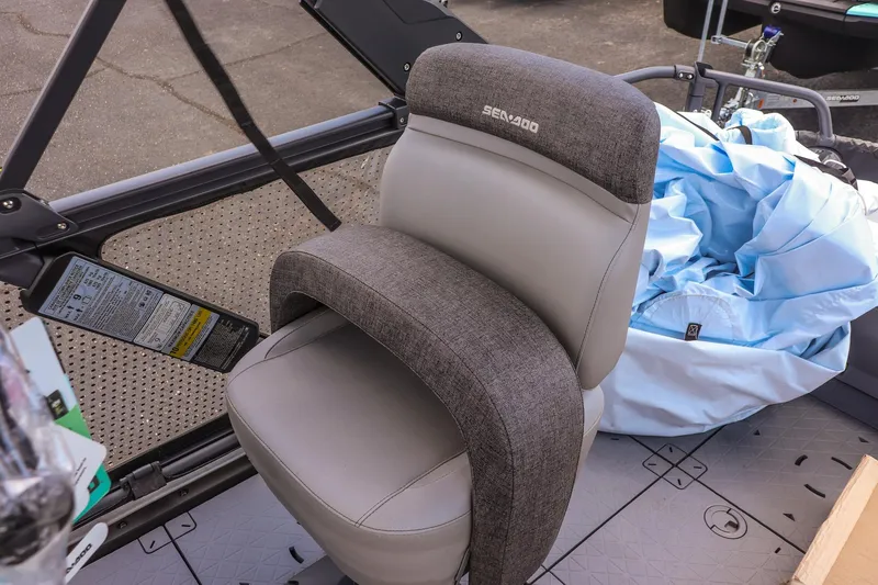 Slide: The Image of 2026 Sea-Doo Switch Cruise 21 seat with gray upholstery and surrounding boat interior. - 17
