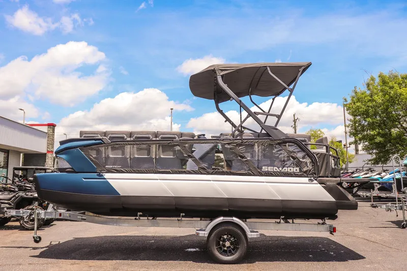 Slide: The Image of 2026 Sea-Doo Switch Cruise 21 pontoon boat on trailer under blue sky. - 6